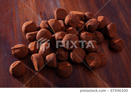 Chocolate truffles on wooden background Chocolate truffles on wooden background 87846300