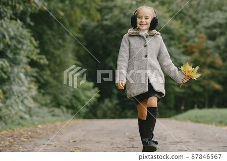 Cute little girl with autumn leaves 87846567