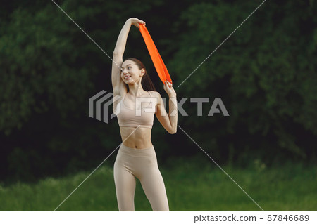 Woman practicing advanced yoga in a beach Woman practicing advanced yoga in a beach 87846689