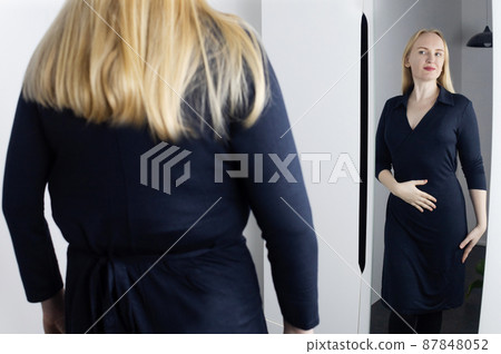 Eating disorder. Woman stands in front of the mirror and sees herself differently. Thin and fat female in frame. Dysmorphophobia or dysmorphia. BDD. Concept of psychological disorders and problems. 87848052