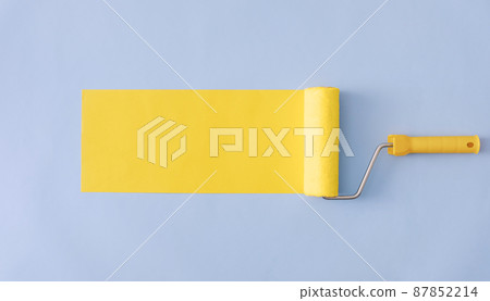 Yellow painted banner with paint roller and copyspace Yellow painted banner with paint roller and copyspace 87852214