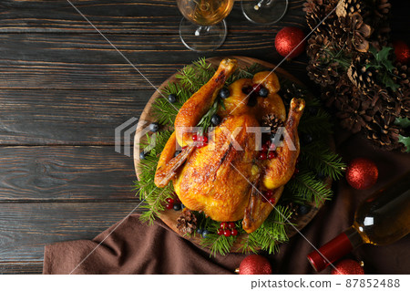 Concept of Christmas roast turkey on wooden table Concept of Christmas roast turkey on wooden table 87852488