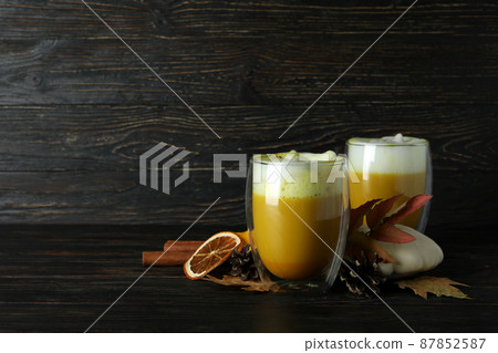 Glasses of pumpkin latte and ingredients on rustic wooden background Glasses of pumpkin latte and ingredients on rustic wooden background 87852587