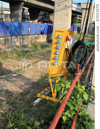 yellow Metal cabinet controls for distribute electrical power a at construction site. 87853879