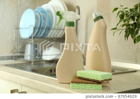 Concept of Dishwashing detergent accessories on kitchen background Concept of Dishwashing detergent accessories on kitchen background 87854029