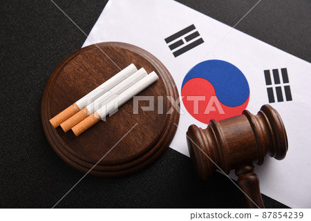 Cigarettes, wooden Judge gavel and South Korea flag. Justice and Tobacco law. Tobacco control act. Top view. Cigarettes, wooden Judge gavel and South Korea flag. Justice and Tobacco law. Tobacco control act. Top view. 87854239