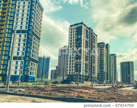 construction of a new residential complex in the city center. high houses made of concrete and glass for people's lives. new neighborhood with smooth roads and traffic lights construction of a new residential complex in the city center. high houses made of concrete and glass for people's lives. new neighborhood with smooth roads and traffic lights 87854700