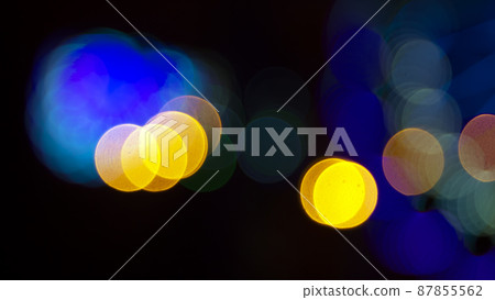 Colored blurred bokeh. abstract background of included festive garlands. colorful blur light bulbs Colored blurred bokeh. abstract background of included festive garlands. colorful blur light bulbs 87855562