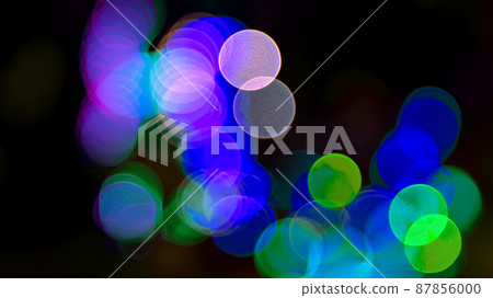 Colored blurred bokeh. abstract background of included festive garlands. colorful blur light bulbs Colored blurred bokeh. abstract background of included festive garlands. colorful blur light bulbs 87856000