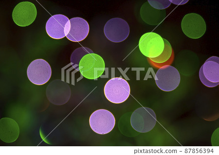 Colored blurred bokeh. abstract background of included festive garlands. colorful blur light bulbs Colored blurred bokeh. abstract background of included festive garlands. colorful blur light bulbs 87856394