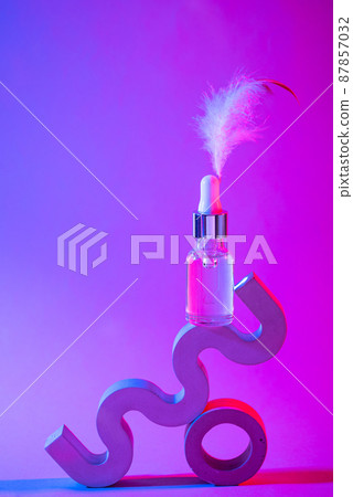 Bottle of cosmetic serum in neon light Bottle of cosmetic serum in neon light 87857032