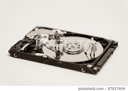 Women clean up a hard drive. Technology concept. Macro photo Women clean up a hard drive. Technology concept. Macro photo 87857404