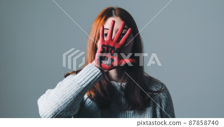 Girl rebels against the system and refuses war by painting her hand red 87858740