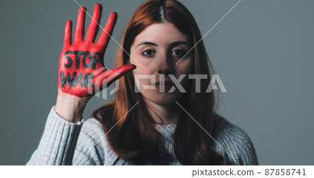 Girl rebels against the system and refuses war by painting her hand red Girl rebels against the system and refuses war by painting her hand red 87858741