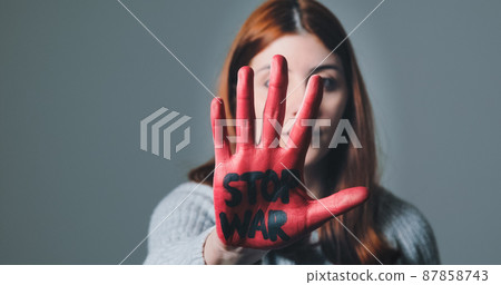 Girl rebels against the system and refuses war by painting her hand red Girl rebels against the system and refuses war by painting her hand red 87858743