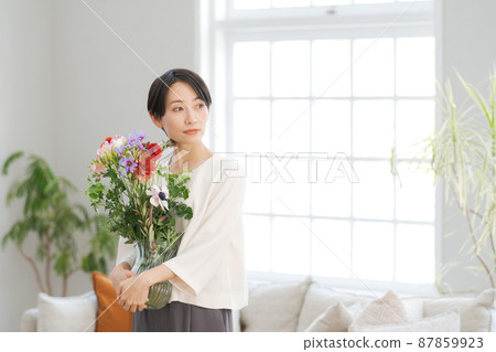 A woman holding a bouquet 87859923