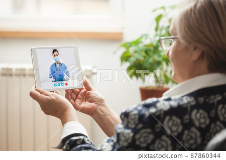 Elderly caucasian woman talking to young female e-doctor via online video chat Elderly caucasian woman talking to young female e-doctor via online video chat 87860344