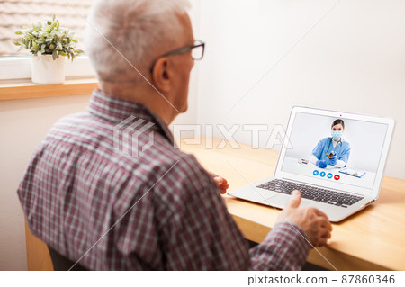 Young female UK e-doctor consulting elderly man, online video help line virtual medical appointment 87860346