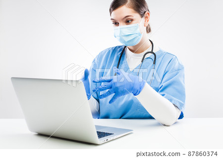 UK NHS GP doctor chatting to patient over computer 87860374