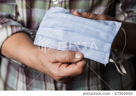 Person holding handmade hand-sewn face mask 87860605