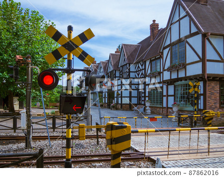 Scenery of a railroad crossing (barrier) where the passing lamp blinks Scenery of a railroad crossing (barrier) where the passing lamp blinks 87862016
