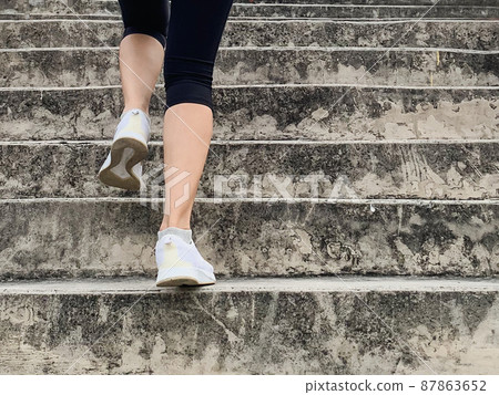 Female runner athlete going up stairs doing cardio sport workout. Female runner athlete going up stairs doing cardio sport workout. 87863652
