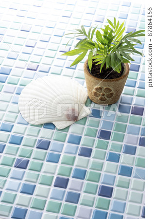Blue tiles, foliage plants and seashells 87864156