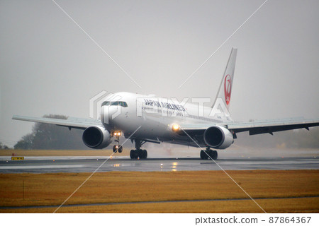 Airplane on a rainy day 87864367