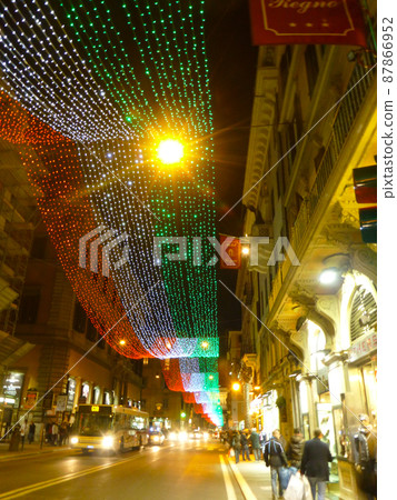 Christmas illuminations colored with national flags on the main street in downtown Rome, Italy Christmas illuminations colored with national flags on the main street in downtown Rome, Italy 87866952