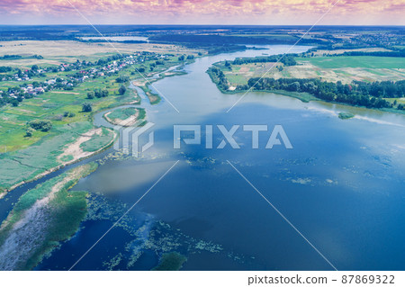 Aerial view of the Zdvizh river near Makariv city, Ukraine. Rural landscape in summer Aerial view of the Zdvizh river near Makariv city, Ukraine. Rural landscape in summer 87869322