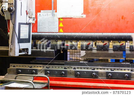 closeup view of industrial sheet bending press brake with tool 87870123