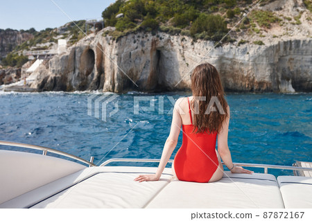 Woman resting on a yacht in the sea in Zakynthos 87872167