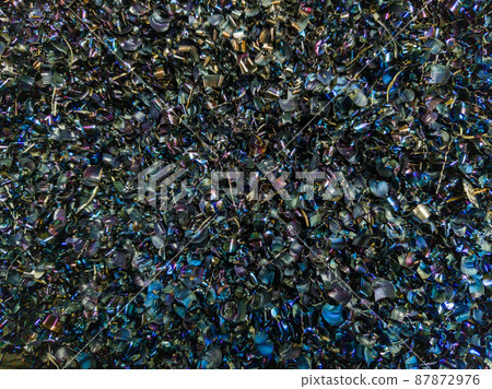 Colored black Steel Chips flat background with natural thermal surface hardening discoloration Colored black Steel Chips flat background with natural thermal surface hardening discoloration 87872976