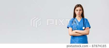 Medical workers, healthcare, covid-19 and vaccination concept. Serious and determined professional female nurse, doctor in blue scrubs with stethoscope, cross arms chest and look camera ready Medical workers, healthcare, covid-19 and vaccination concept. Serious and determined professional female nurse, doctor in blue scrubs with stethoscope, cross arms chest and look camera ready 87874185