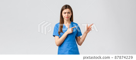 Healthcare workers, prevent virus, insurance and medicine concept. Skeptical, displeased nurse or doctor found something suspicious or bad, pointing fingers right, frowning and smirk concerned 87874229