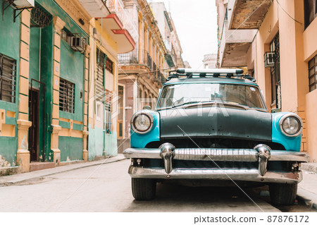 View of yellow classic vintage car in Old Havana, Cuba View of yellow classic vintage car in Old Havana, Cuba 87876172