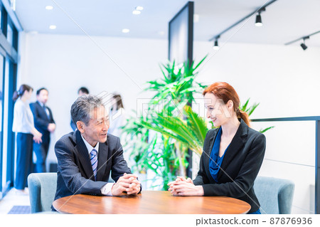Business person having a meeting in the hotel lobby 87876936