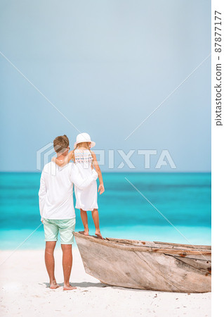 Little girl and happy dad having fun during beach vacation 87877177