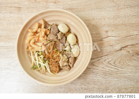 boiled dry thin rice noodles topping slice braised pork and meatball dressing sweet black soybean sauce on bowl boiled dry thin rice noodles topping slice braised pork and meatball dressing sweet black soybean sauce on bowl 87877801