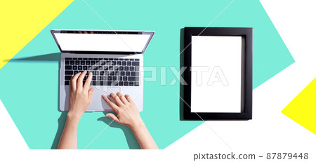 Laptop computer with a blank photo frame Laptop computer with a blank photo frame 87879448