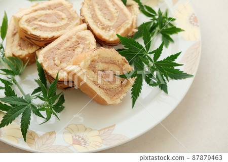 Sweet roll with marijuana oil on white plate. Cannabis kitchen 87879463