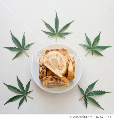 Sweet roll with marijuana oil on white plate. Cannabis kitchen 87879464