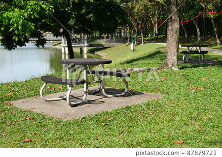 MELAKA, MALAYSIA -MARCH 29, 2021: Public benches are built in public areas and parks. Used to relieve fatigue, relax or socialize. Built using weather-resistant materials. 87879721