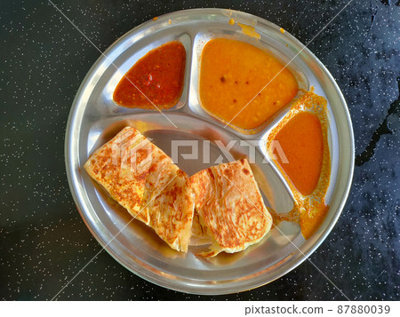 Traditional Malaysian signature flatbread food is called roti canai.  This is the type of pancake made from a mix of flour, egg and water. Eat with special sauce. 87880039