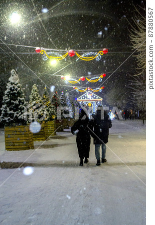 City street during snowfall at winter night. Beautiful illumination 87880567