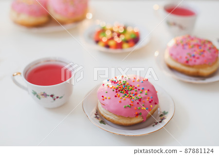 holiday, birthday party composition with colorful pink glazed donuts on white table, flatlay top view 87881124
