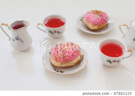 holiday, birthday party composition with colorful pink glazed donuts on white table, flatlay top view 87881125