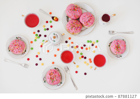 holiday, birthday party composition with colorful pink glazed donuts on white table, flatlay top view holiday, birthday party composition with colorful pink glazed donuts on white table, flatlay top view 87881127