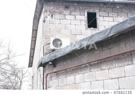 MARIUPOL, UKRAINE - March. 5, 2022: War of Russia against Ukraine. Wall Residential Building damaged by an enemy aircraft, artillery bombs in the Ukrainian city Mariupol. MARIUPOL, UKRAINE - March. 5, 2022: War of Russia against Ukraine. Wall Residential Building damaged by an enemy aircraft, artillery bombs in the Ukrainian city Mariupol. 87882138
