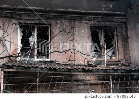MARIUPOL, UKRAINE - March. 5, 2022: War of Russia against Ukraine. Residential Building damaged by an enemy aircraft, artillery all burnt in the Ukrainian city Mariupol. MARIUPOL, UKRAINE - March. 5, 2022: War of Russia against Ukraine. Residential Building damaged by an enemy aircraft, artillery all burnt in the Ukrainian city Mariupol. 87882148